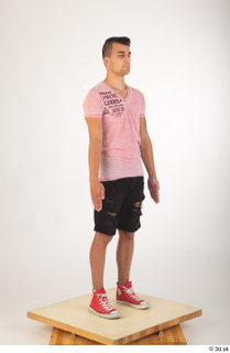 Colin black shorts clothing pink t shirt red shoes standing…